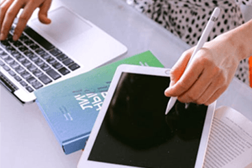 Person at desk with MacBook and iPad