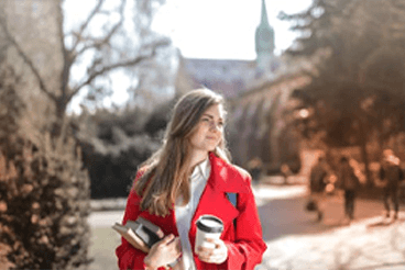 Young adult on campus with coffee cup